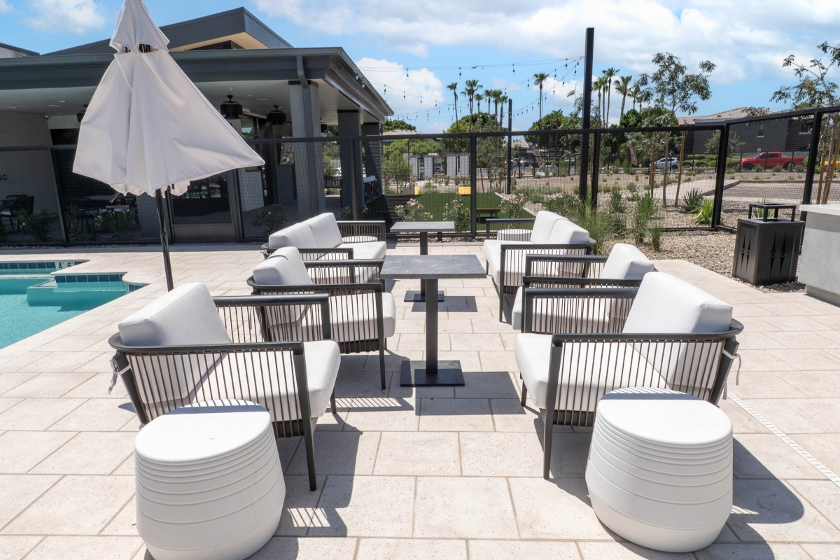 Shaded outdoor seating beside the pool